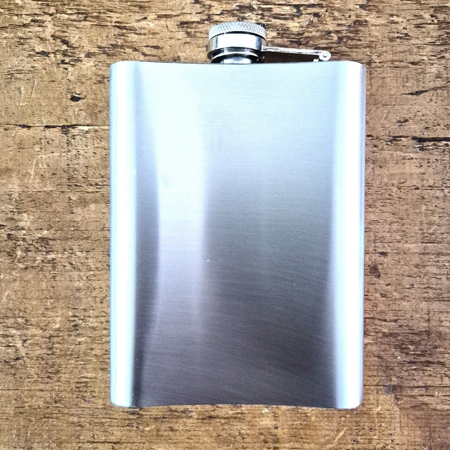 Stainless steel flask on a wooden surface