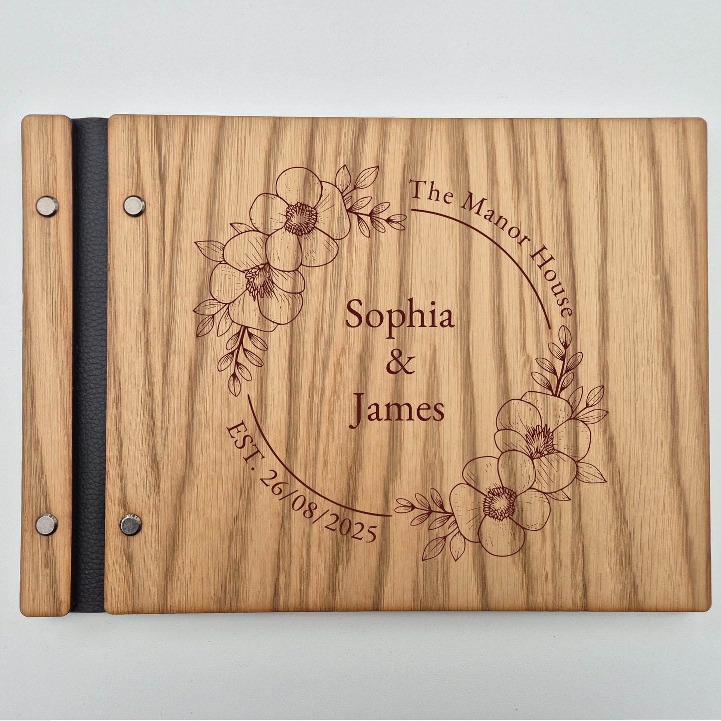 Image of a rustic style oak wedding book. The book is approximately 298mm x 216mm and includes high quality paper. The oak wedding book is laser engraved by laserengraveuk.com with a floral circular design to the front. The dsign includes the married couples names, date of wedding and the venue.