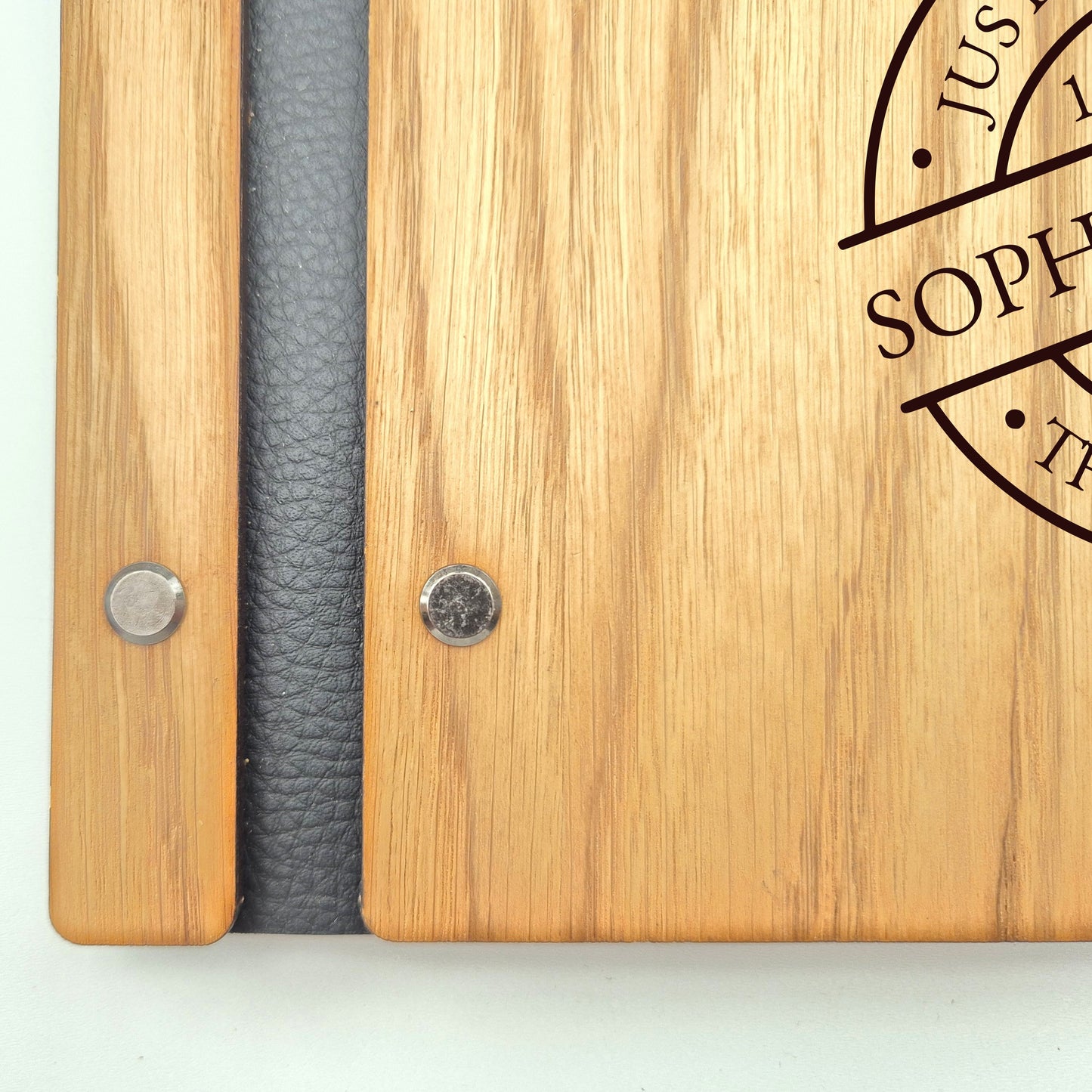 Image of a rustic style oak wedding book. The book is approximately 298mm x 216mm and includes high quality paper. The oak wedding book is laser engraved by laserengraveuk with a circular just married stamp design to the front. The design includes the married couple's names, date of wedding, and the venue.