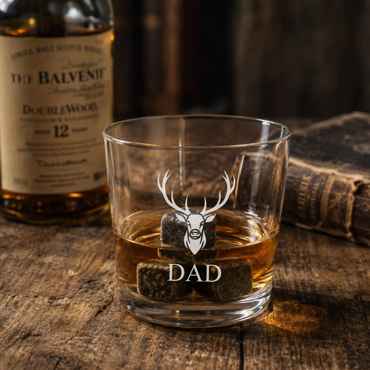 Personalised father's day whisky glass on wooden surface.