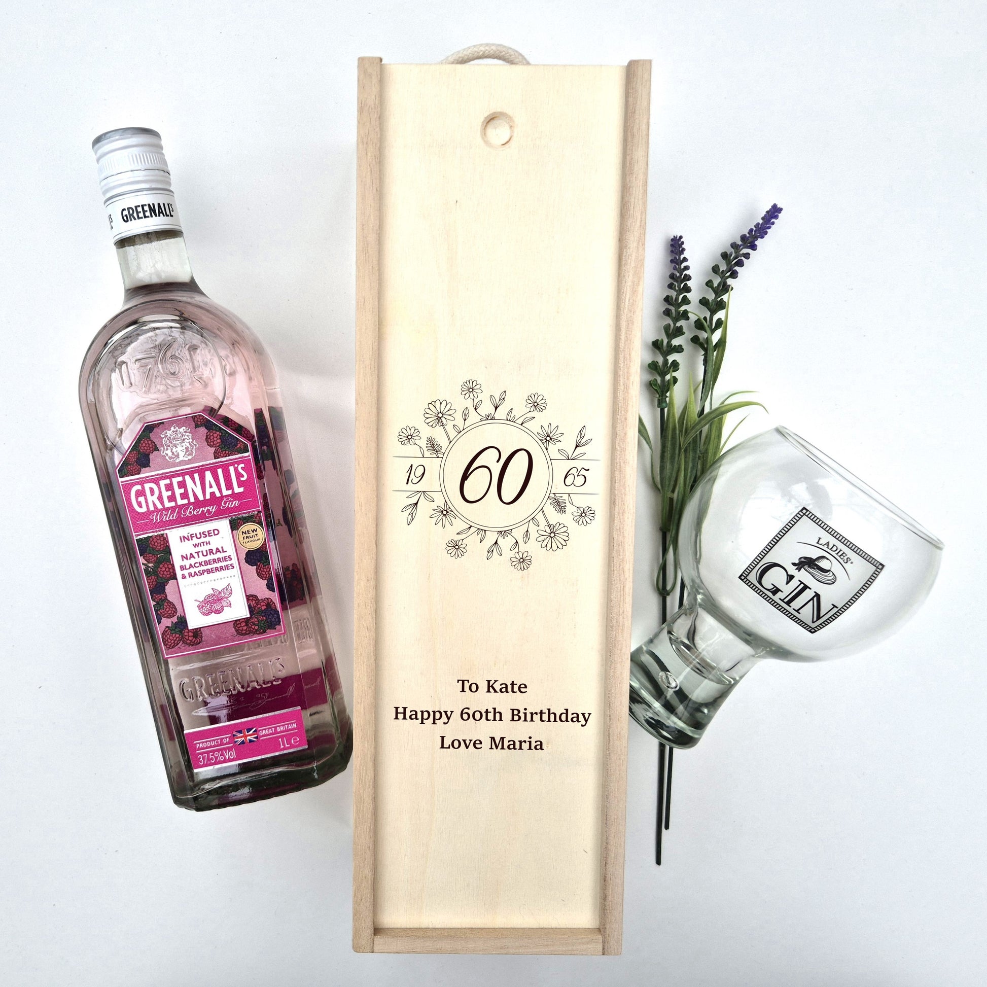 60th birthday champagne bottle box next to a bottle of gin 