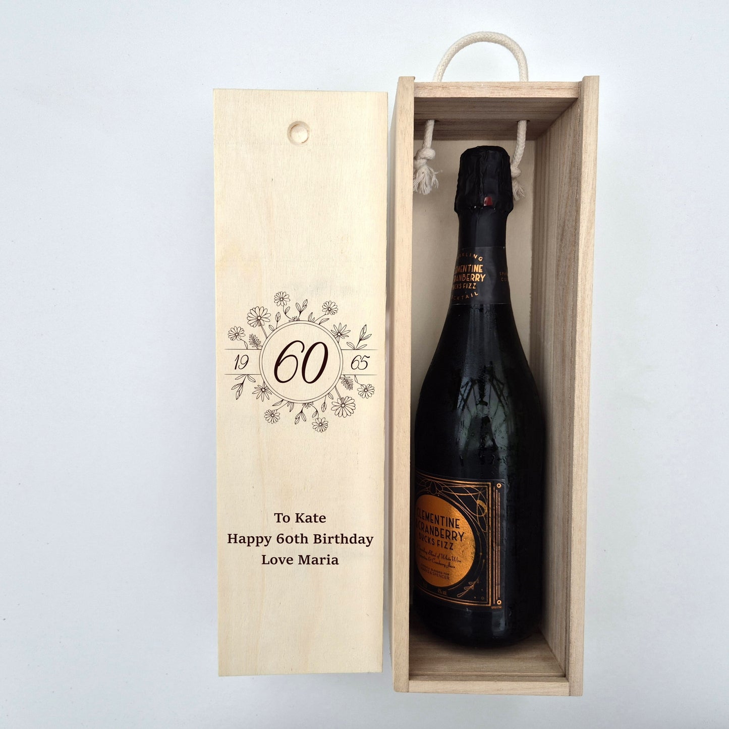 60th birthday champagne bottle box next to a bottle