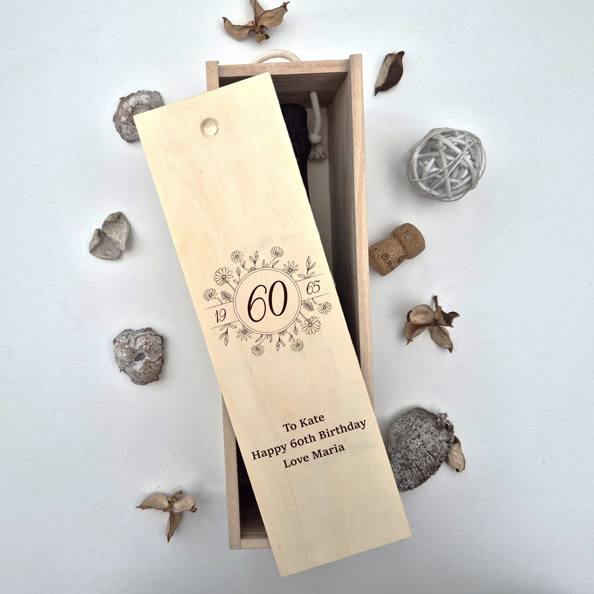 60th birthday champagne bottle box next to a number of shaped objects 