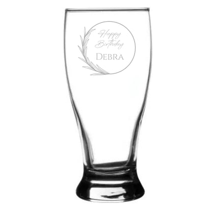 Clear glass beer mug with engraved 'Happy Birthday Debra' text on a white background