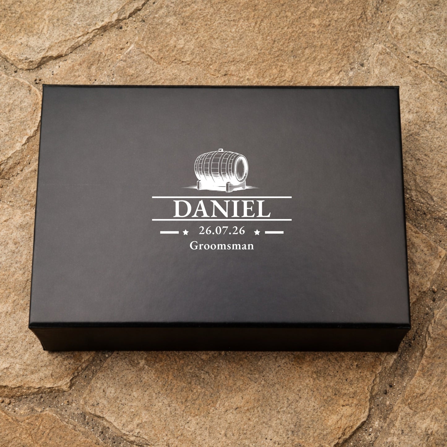 Black box with white text and design on a stone surface