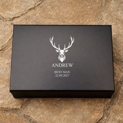 Black box with a deer logo and text on a stone surface