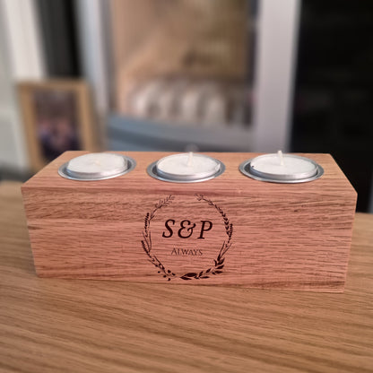 Oak tea light holder with engraved initials 'S&P' on a table.