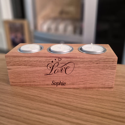 Oak tealight holder with 'Love Sophie' engraving on a wooden surface.