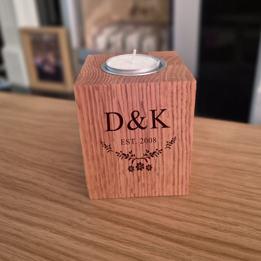 Oak tealight holder with 'D&K EST. 2008' engraving on a wooden surface.