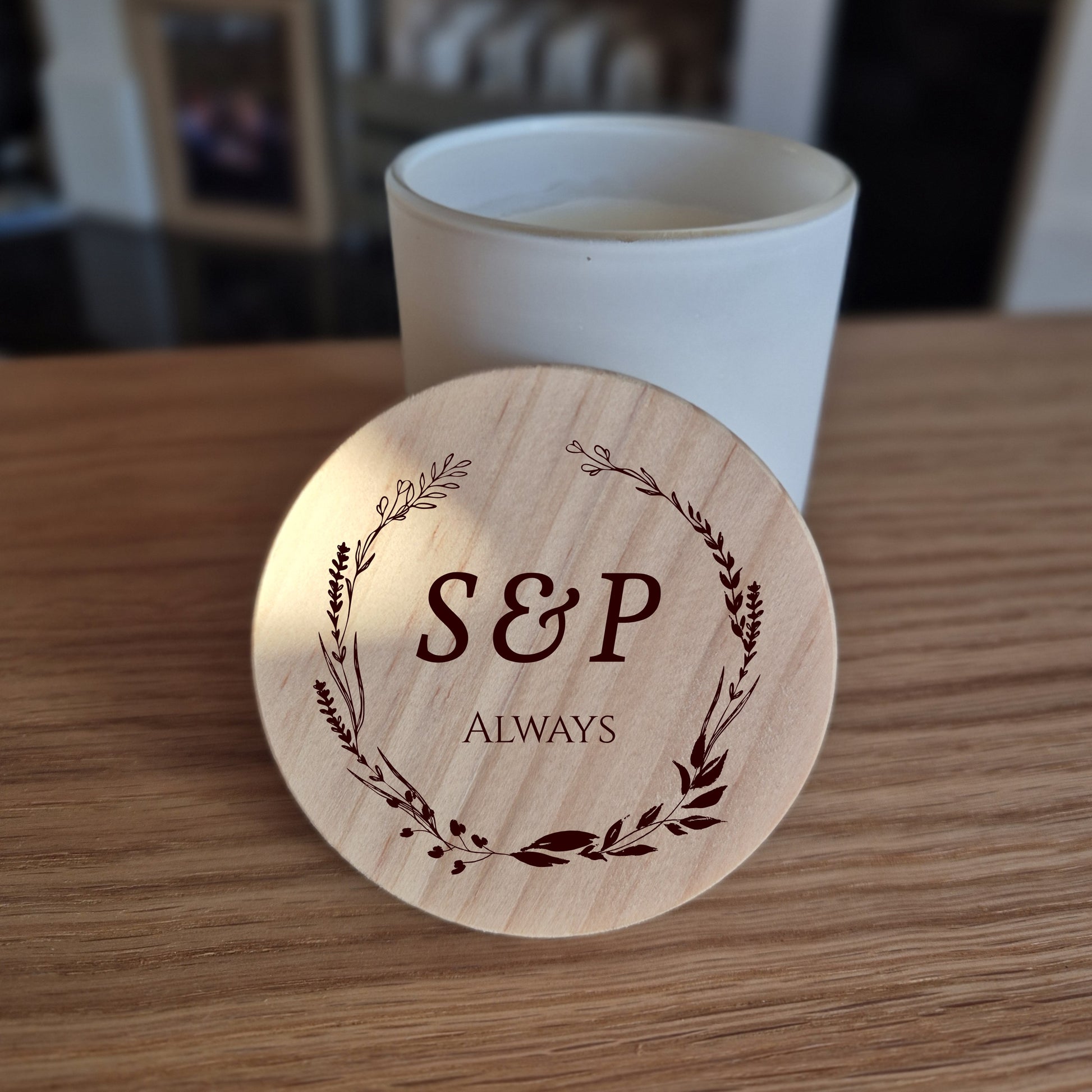 White jar candle with engraved wooden lid with 'S&P Always' design.