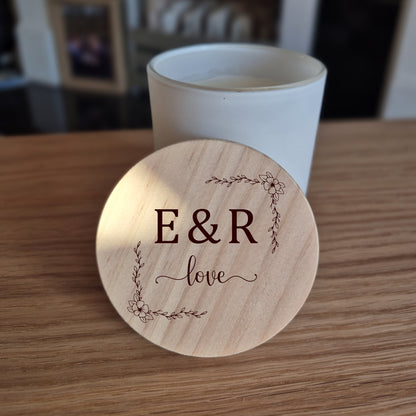 White jar candle with engraved wooden lid with 'E&R love' engraving. 