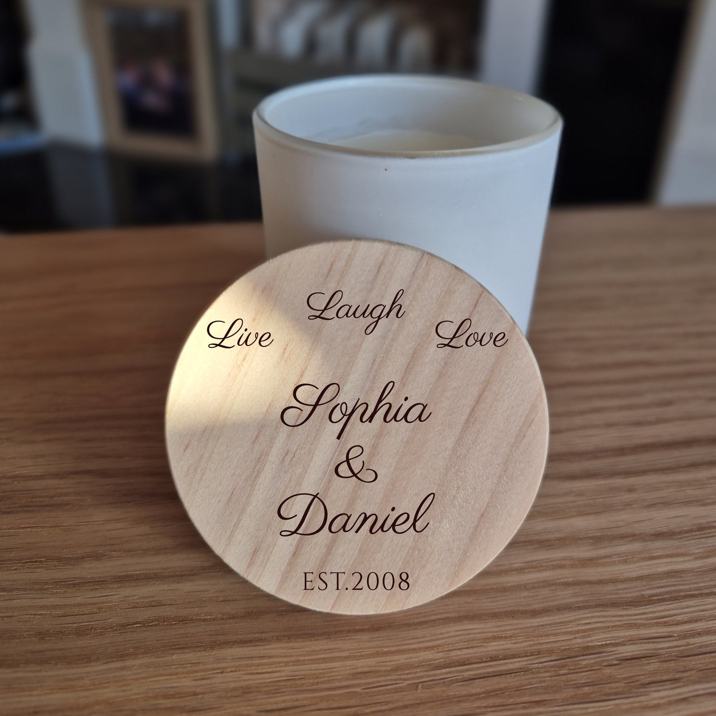 White jar candle with engraved wooden lid. 