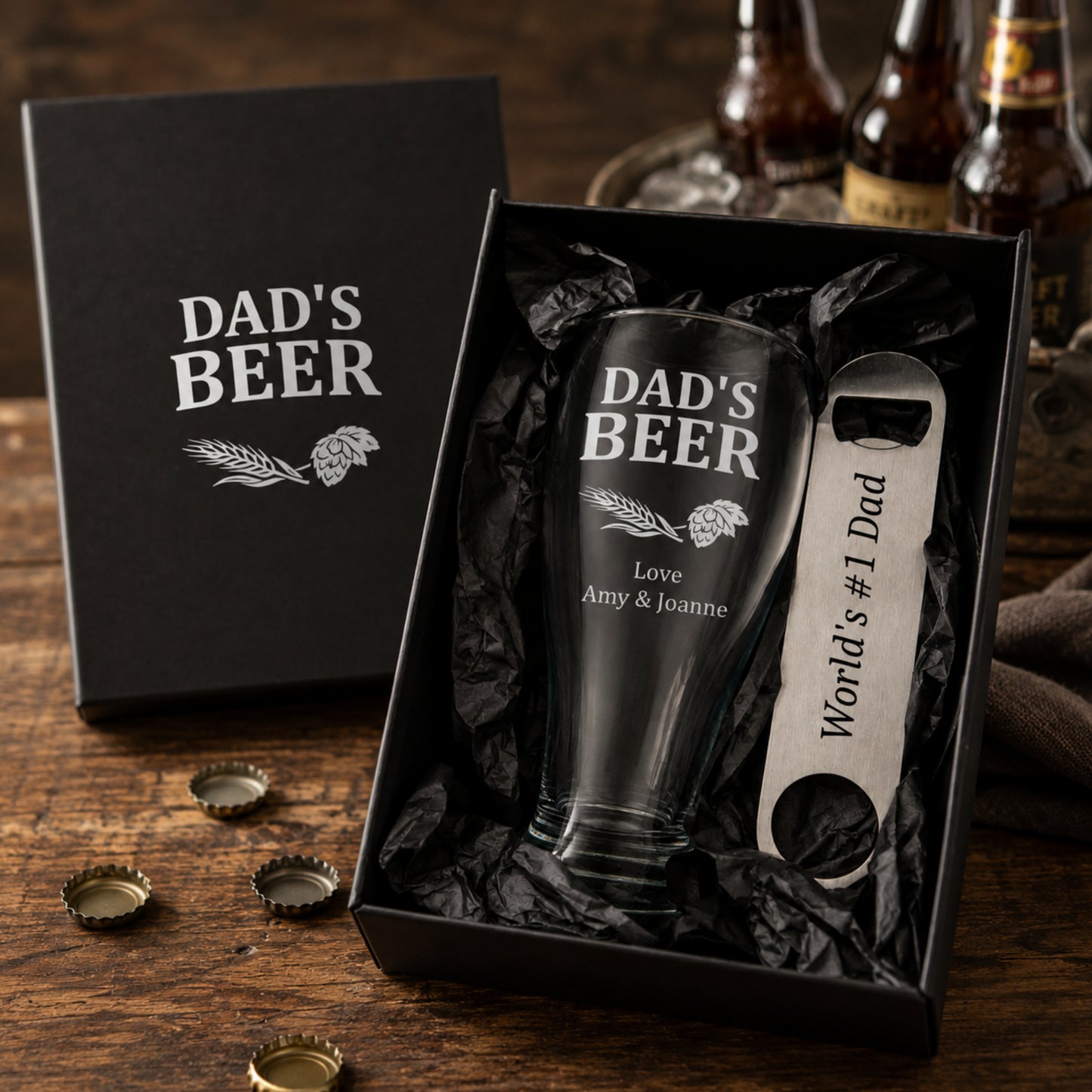 Gift set with 'Dad's Beer' glass and opener in a black box on a wooden surface.