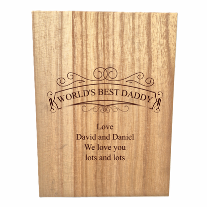 Wooden whisky set with engraved text 'World's Best Daddy' on a white background