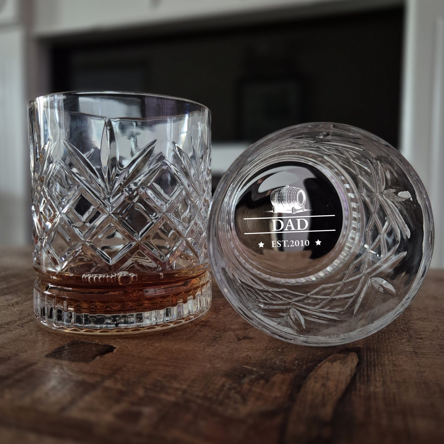 Crystal glass with engraved lid on a wooden surface