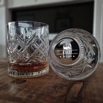 Crystal glass with engraved lid on a wooden surface
