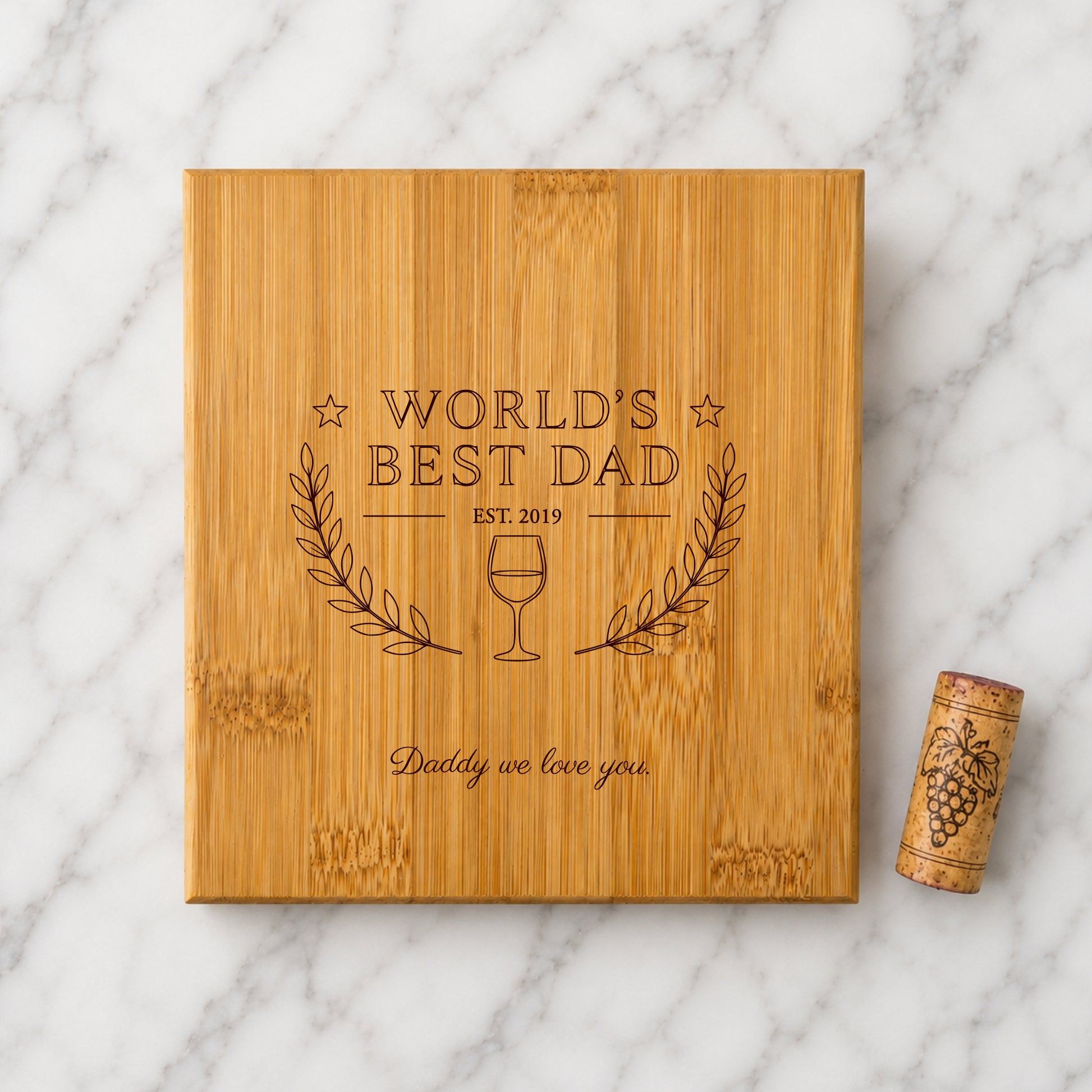 Wooden box with 'World's Best Dad' engraving on a marble surface