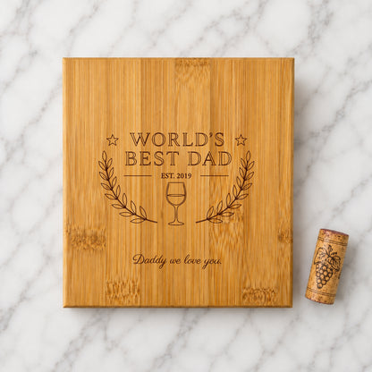 Wooden box with 'World's Best Dad' engraving on a marble surface