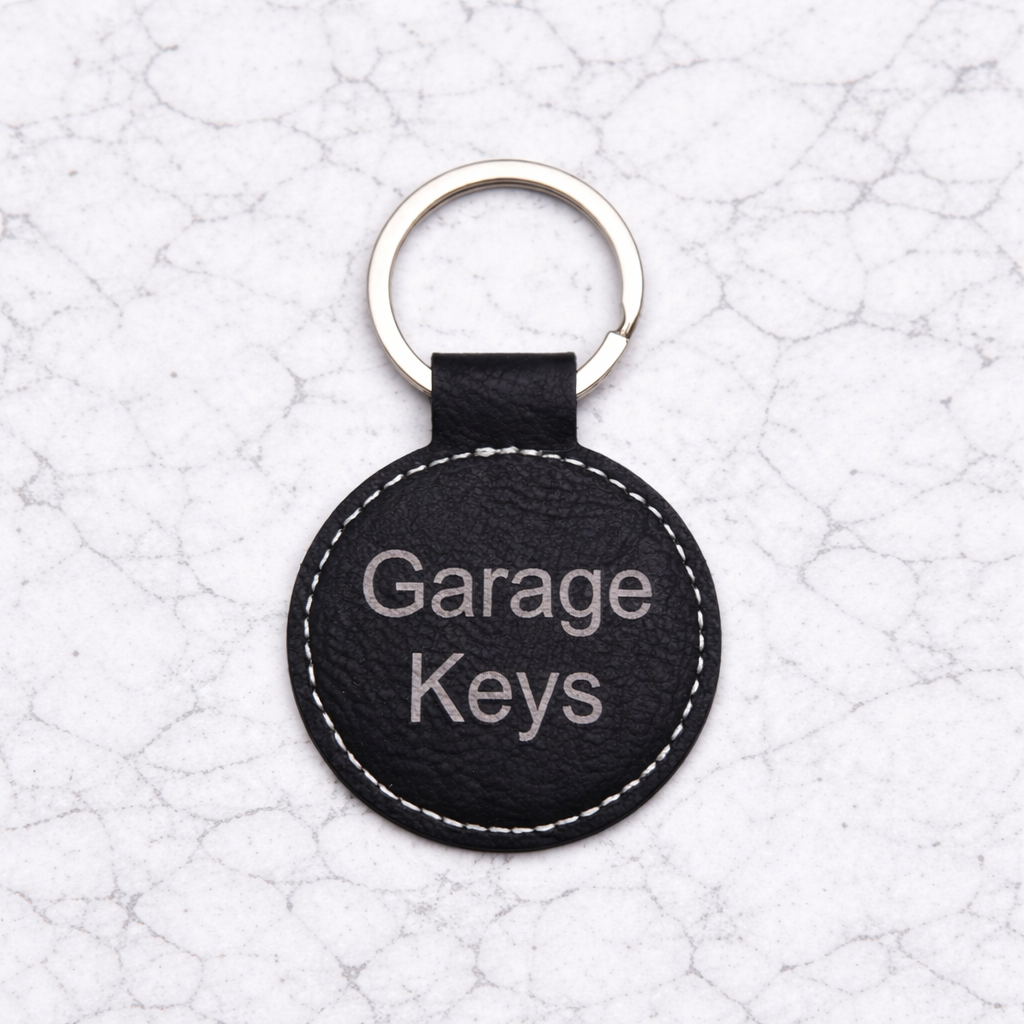 Black leather keychain with 'Garage Keys' text on a textured white background