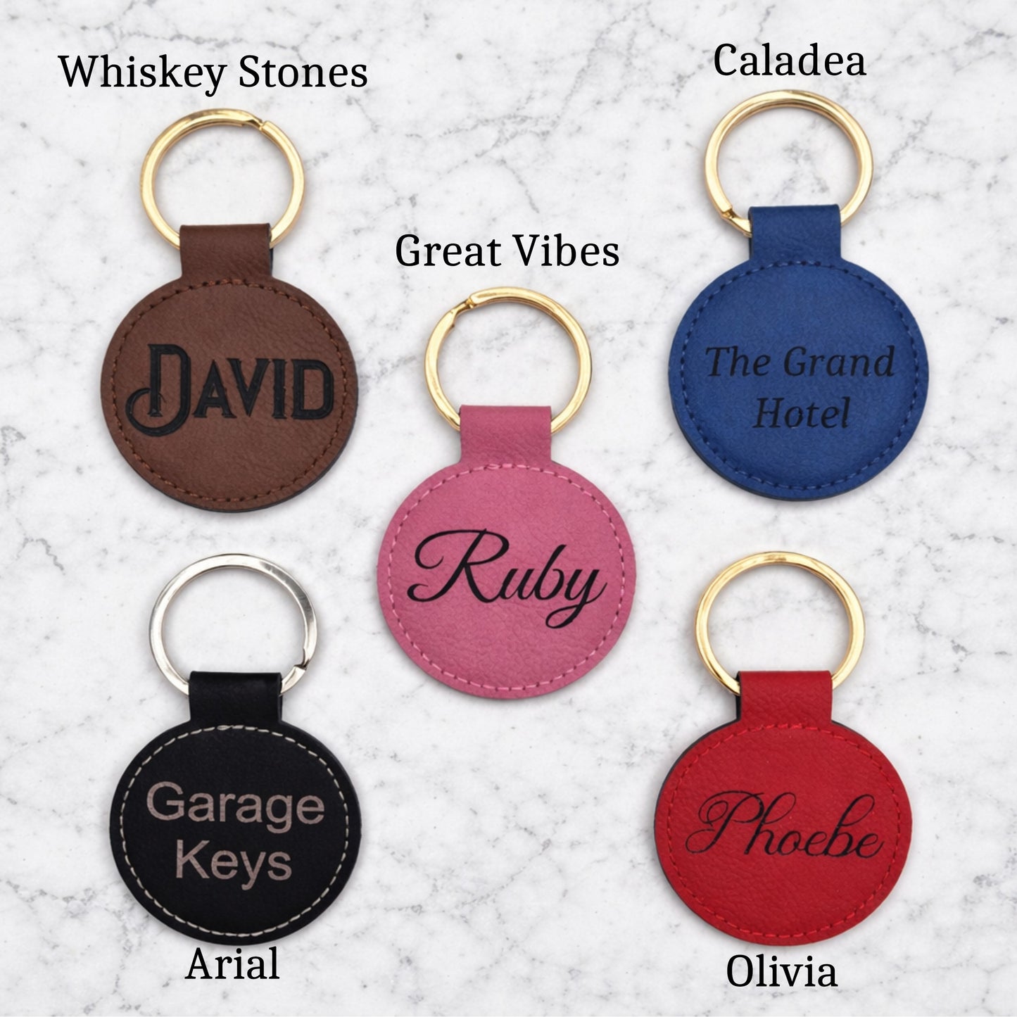 Set of round leather keychains with names engraved on a textured surface