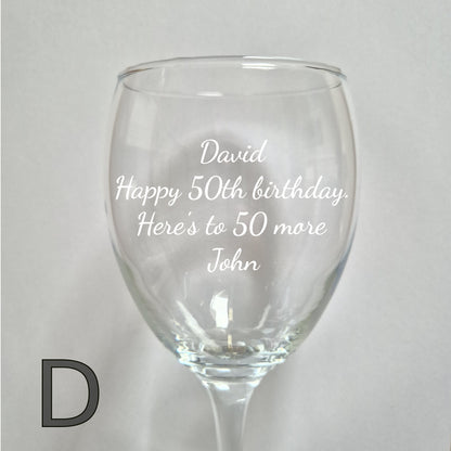 Personalised wine glass with engraved birthday message on a light gray background