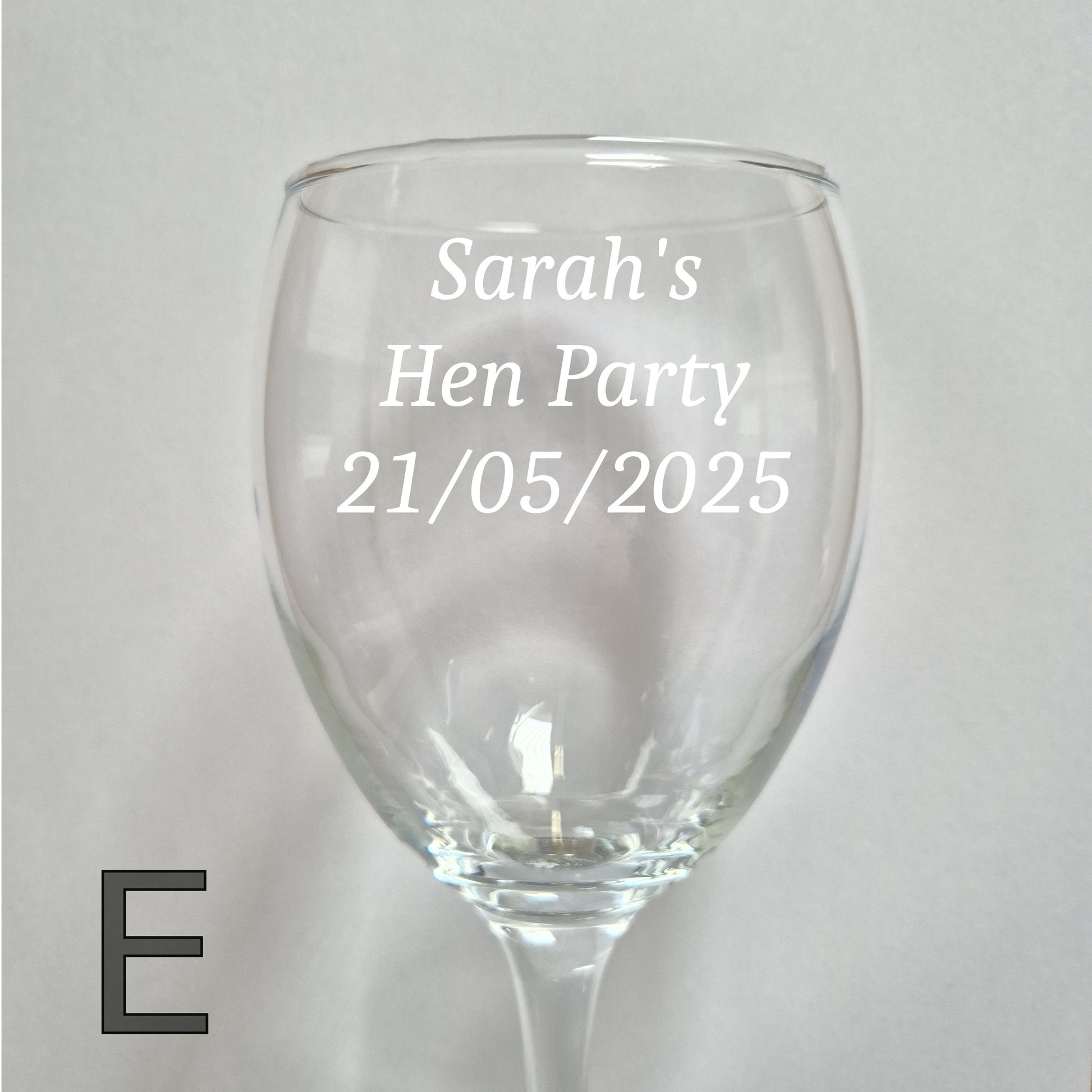 Personalised wine glass with 'Sarah's Hen Party 21/05/2025' text on a light gray background
