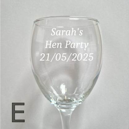 Personalised wine glass with 'Sarah's Hen Party 21/05/2025' text on a light gray background