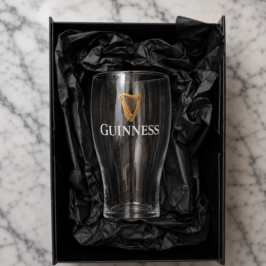 Guinness glass in a black gift box on a marble surface