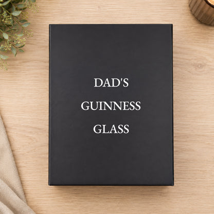 Black box with 'DAD'S GUINNESS GLASS' text on a wooden surface