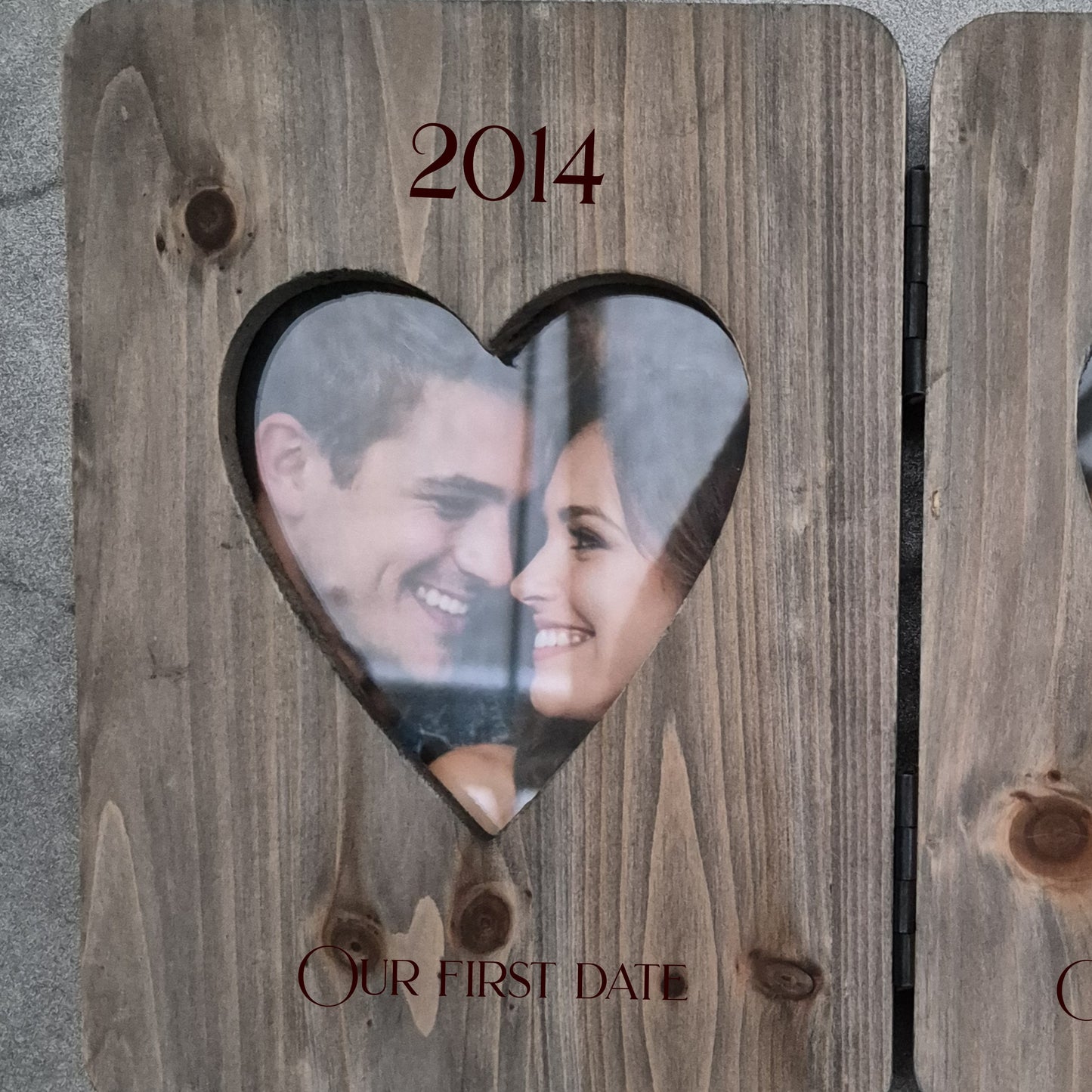 Double photo frame with heart cutouts showing a couple's photos from 2014 and 2025.