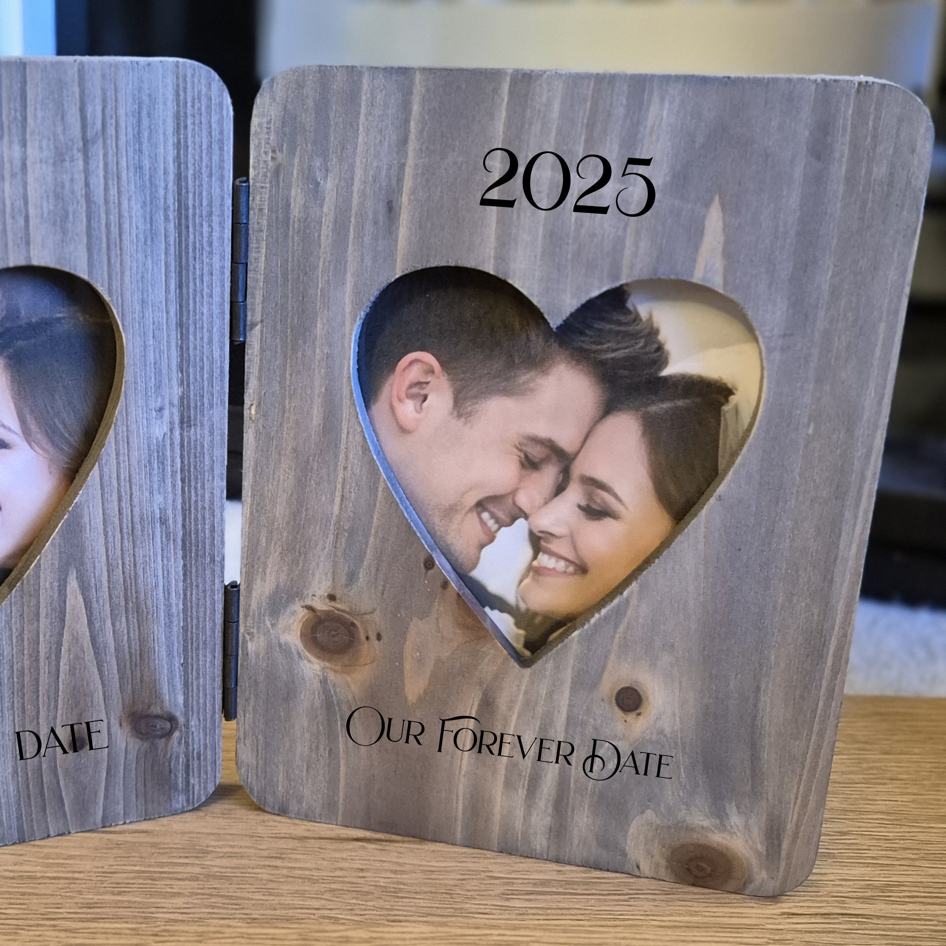 Double photo frame with heart cutouts showing a couple's photos from 2014 and 2025.