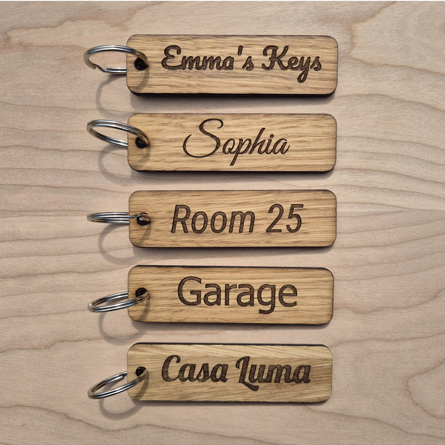 5 Oak keyrings measureing 90 x 25 x 4mm. Each keyring is engraved in a different font.