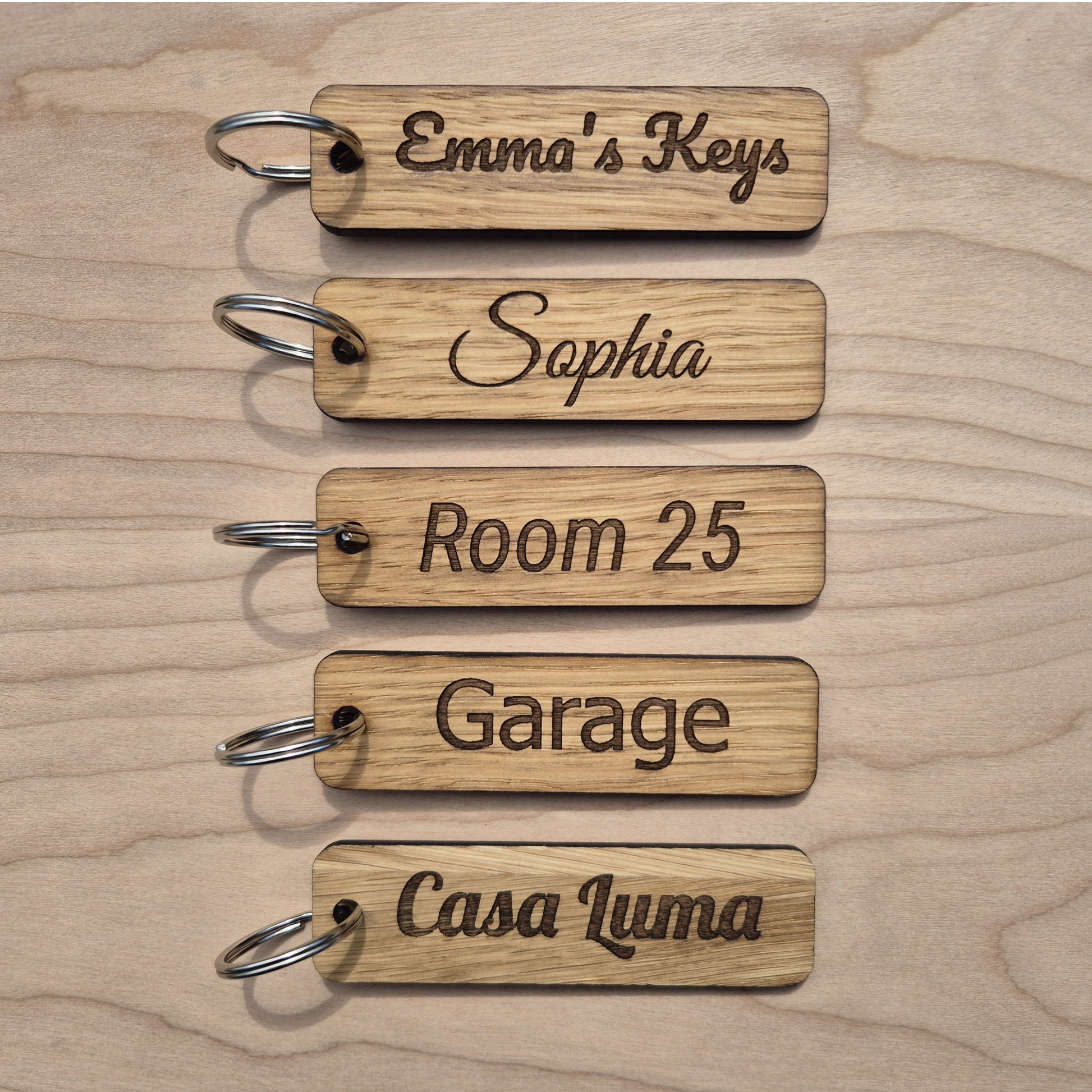 5 Oak keyrings measureing 90 x 25 x 4mm. Each keyring is engraved in a different font.