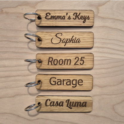 5 Oak keyrings measureing 90 x 25 x 4mm. Each keyring is engraved in a different font.