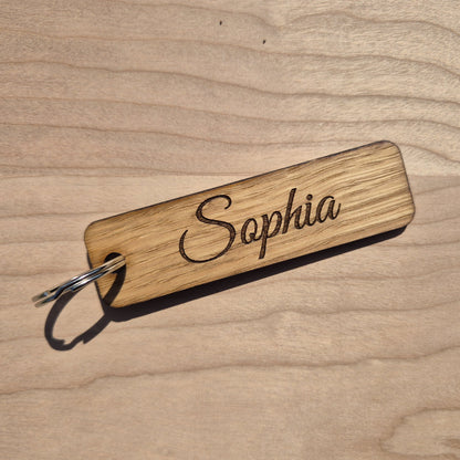 Oak keyrings measureing 90 x 25 x 4mm. Each keyring is engraved in a different font. This keyring says Sophia.