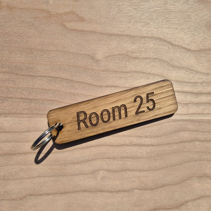 Oak keyrings measureing 90 x 25 x 4mm. Each keyring is engraved in a different font. This keyring says room 25