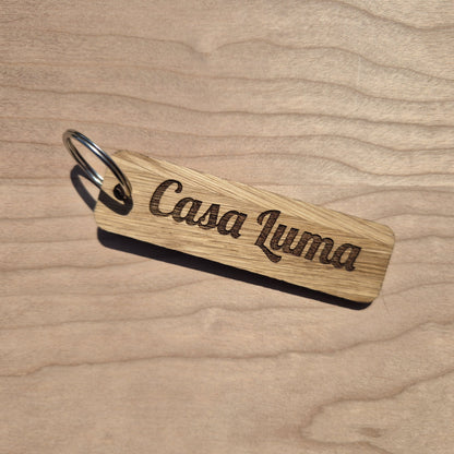 Oak keyrings measureing 90 x 25 x 4mm. Each keyring is engraved in a different font. This keyring says Casa Luma.