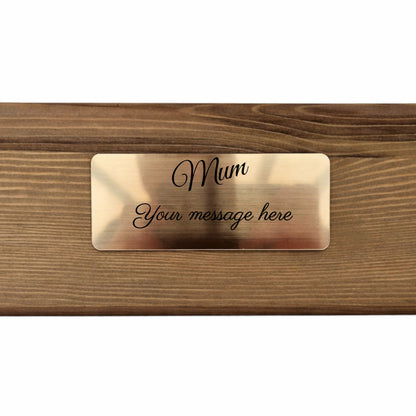 Brass nameplate with 'Mum' engraved on a wooden planter