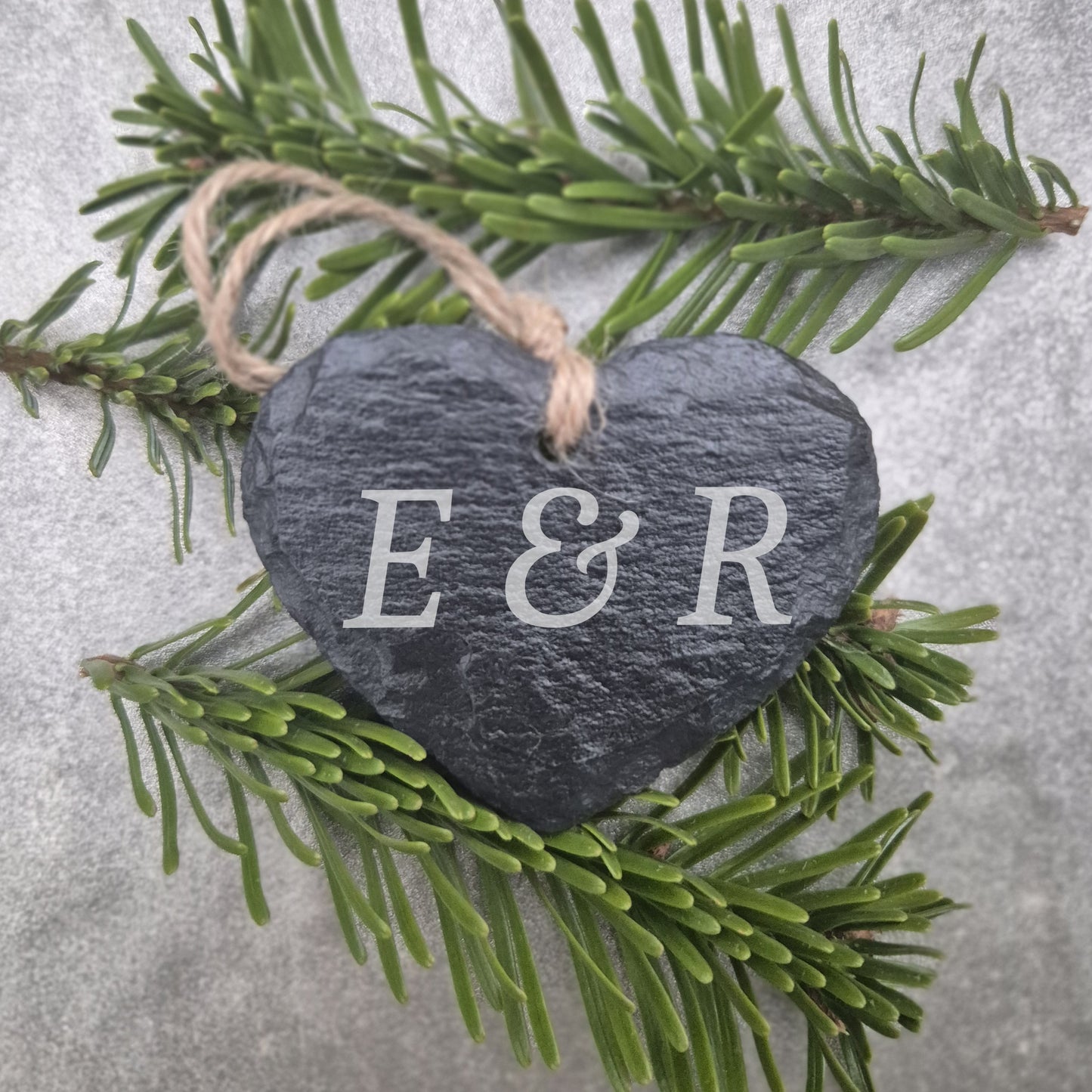 Heart-shaped slate ornament with 'E & R' on a branch