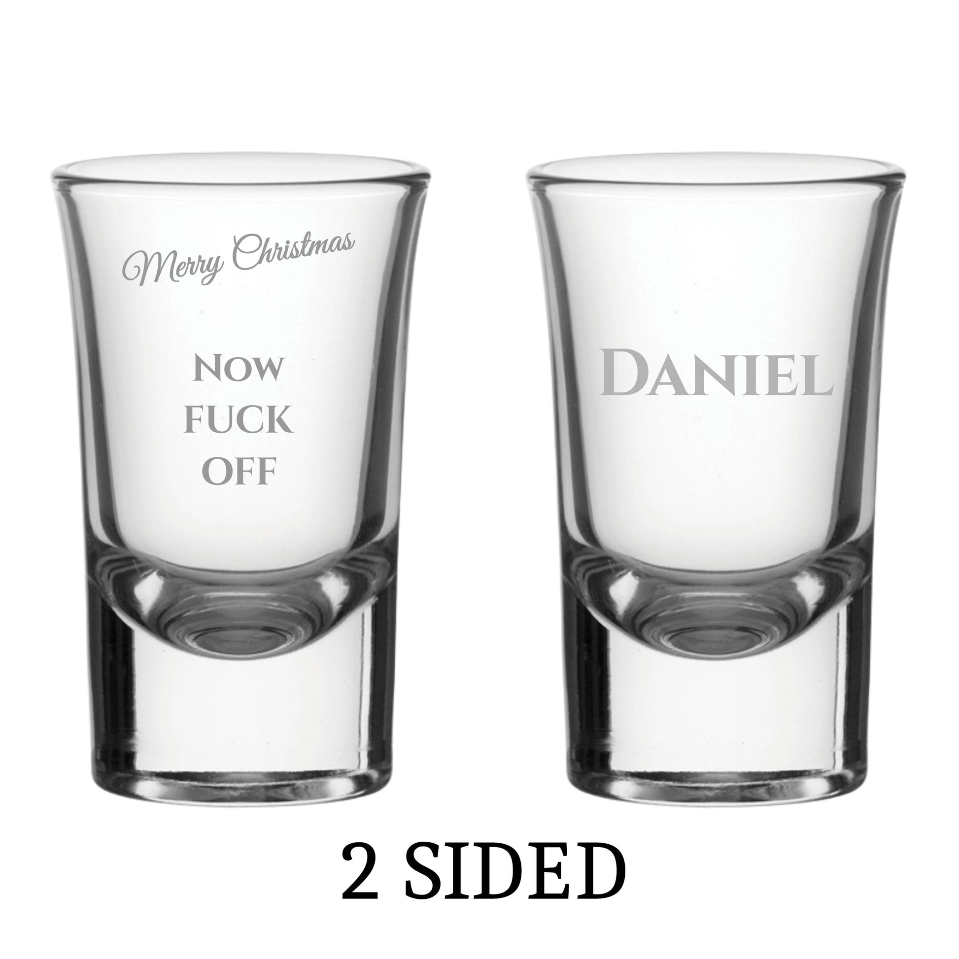 Two clear shot glasses with printed text on a white background