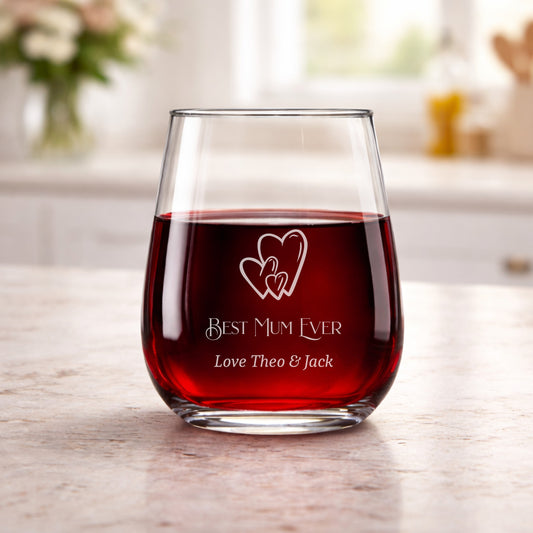 Glass of red wine with 'Best Mum Ever' engraving on a wooden table