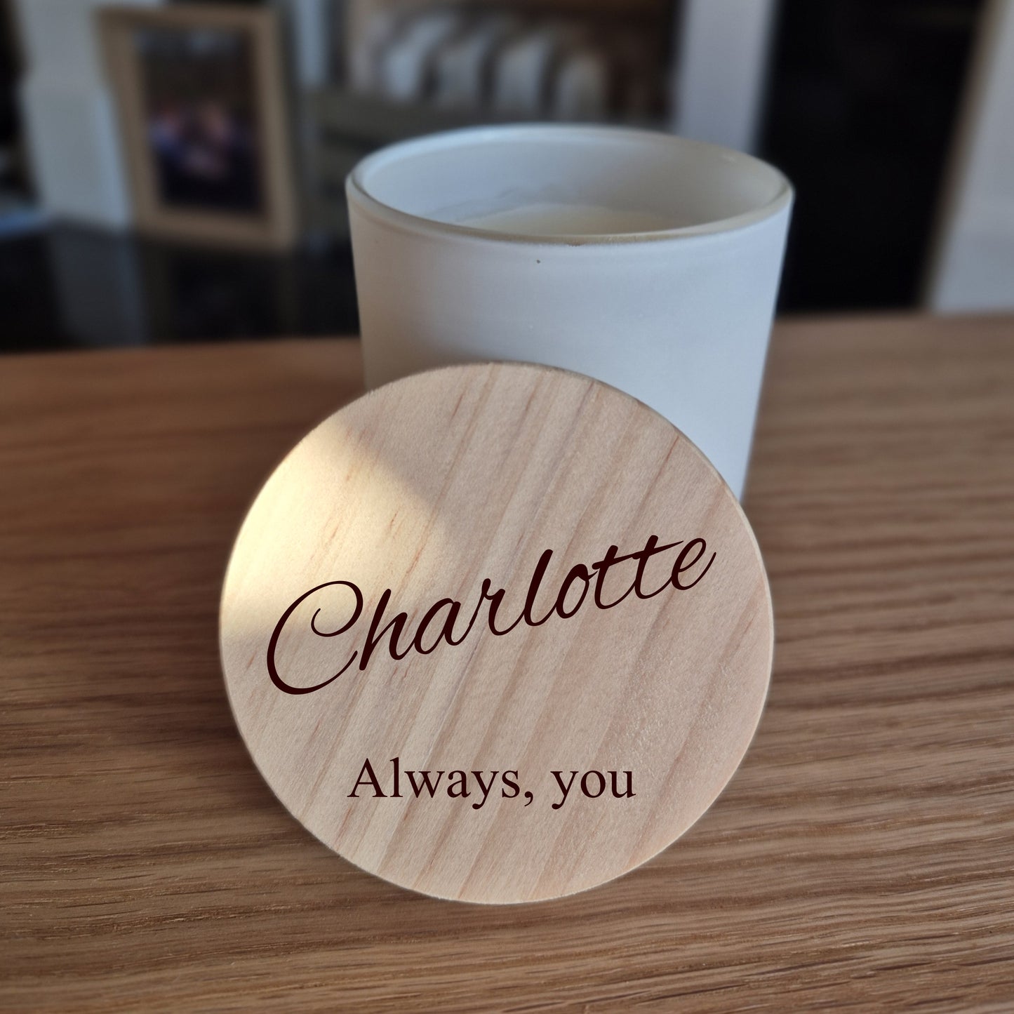 Personalised soy candle with wooden engraved lid. 'Charlotte Always, you' engraved on a wooden lid with a blurred background