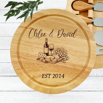Wooden cheese board with engraved design of a bottle of wine, glass, and food, along with 'Chloe & David EST 2014' text.