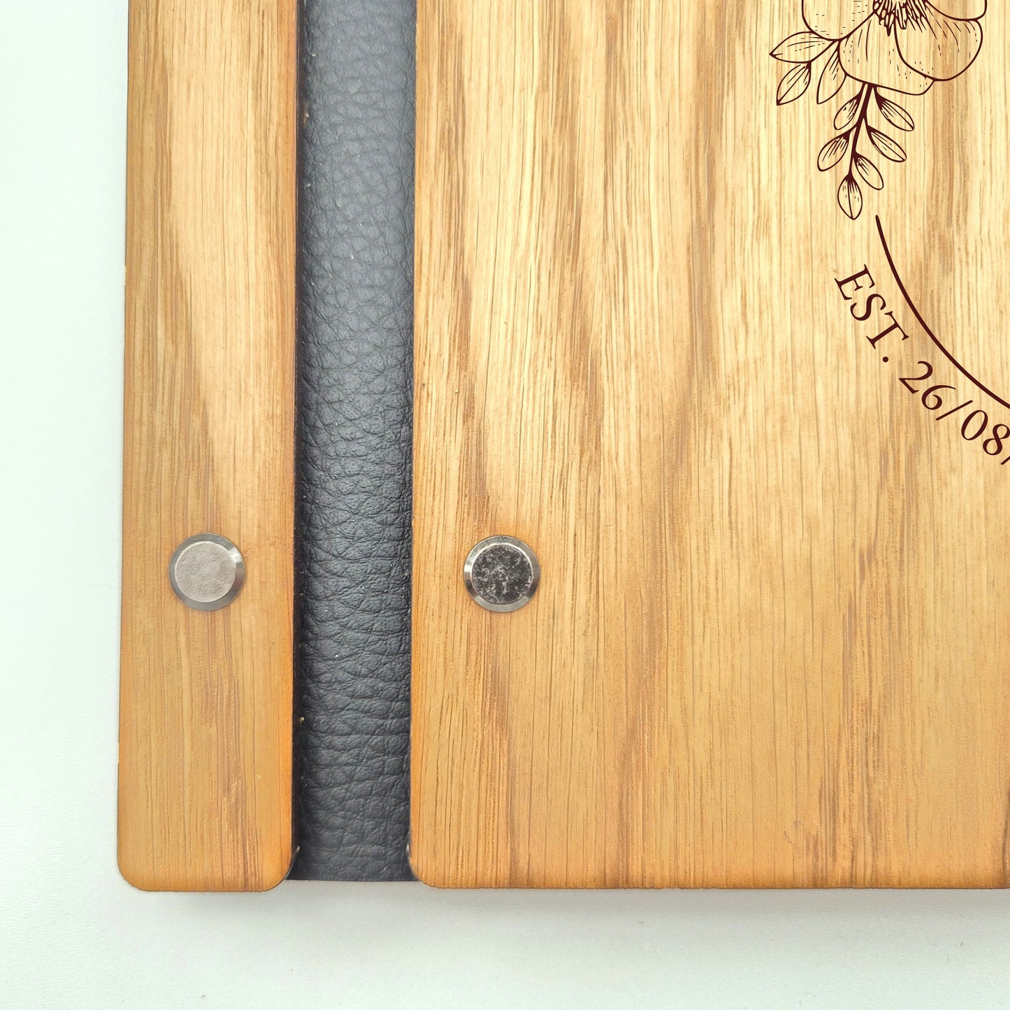 Image of a rustic style oak wedding book. The book is approximately 298mm x 216mm and includes high quality paper. The oak wedding book is laser engraved by laserengraveuk.com with a floral circular design to the front. The dsign includes the married couples names, date of wedding and the venue.