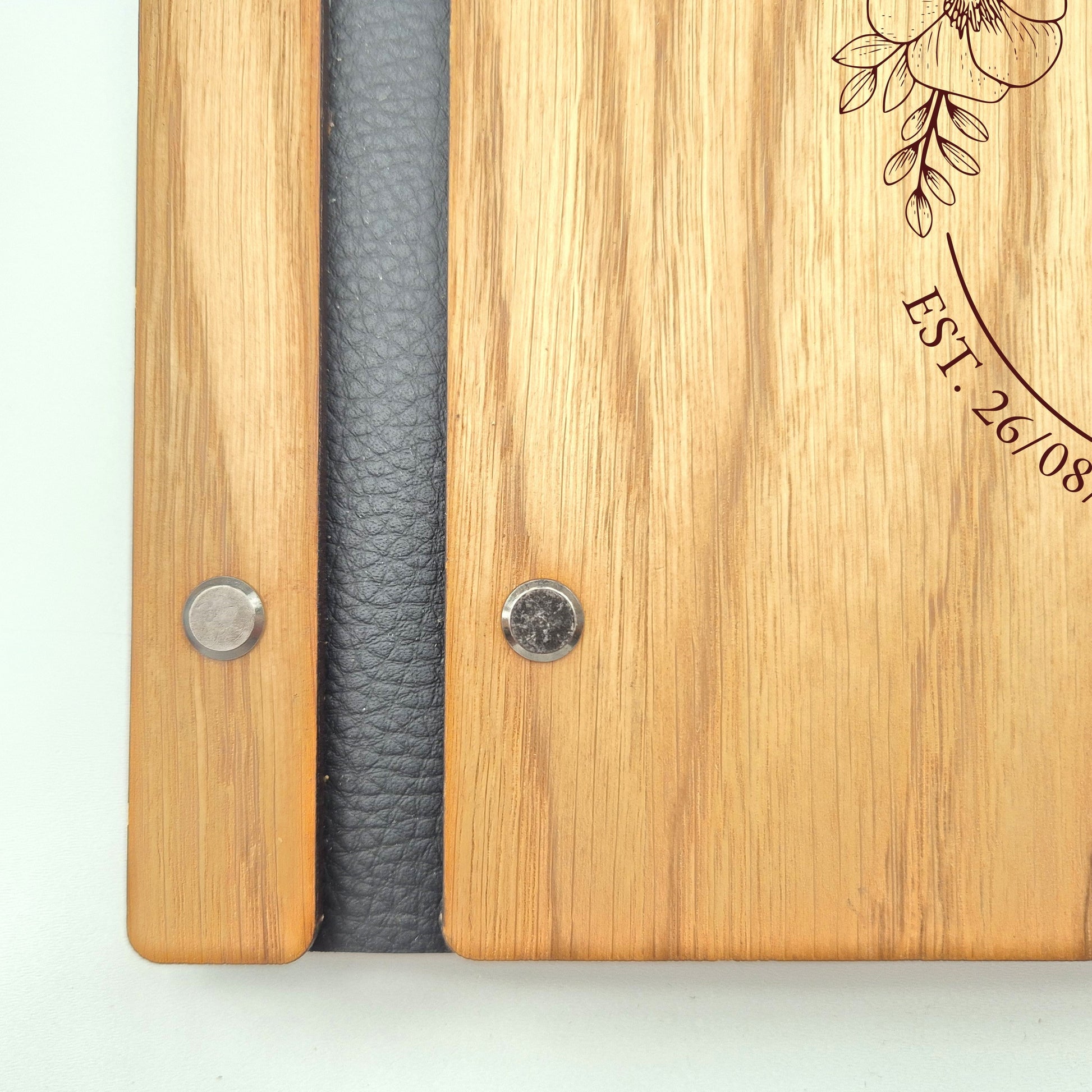 Image of a rustic style oak wedding book. The book is approximately 298mm x 216mm and includes high quality paper. The oak wedding book is laser engraved by laserengraveuk.com with a floral circular design to the front. The dsign includes the married couples names, date of wedding and the venue.