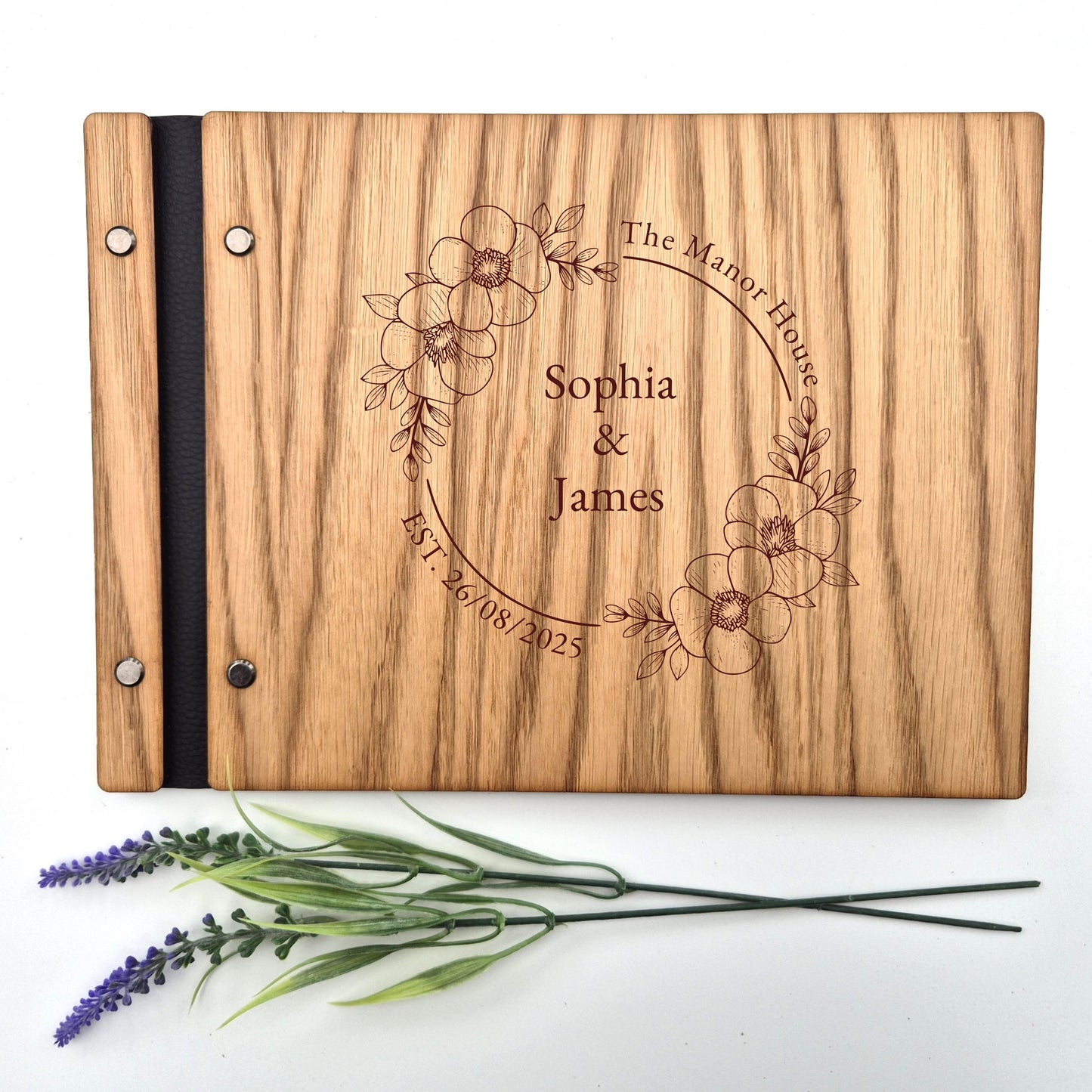 Image of a rustic style oak wedding book. The book is approximately 298mm x 216mm and includes high quality paper. The oak wedding book is laser engraved by laserengraveuk.com with a floral circular design to the front. The dsign includes the married couples names, date of wedding and the venue.