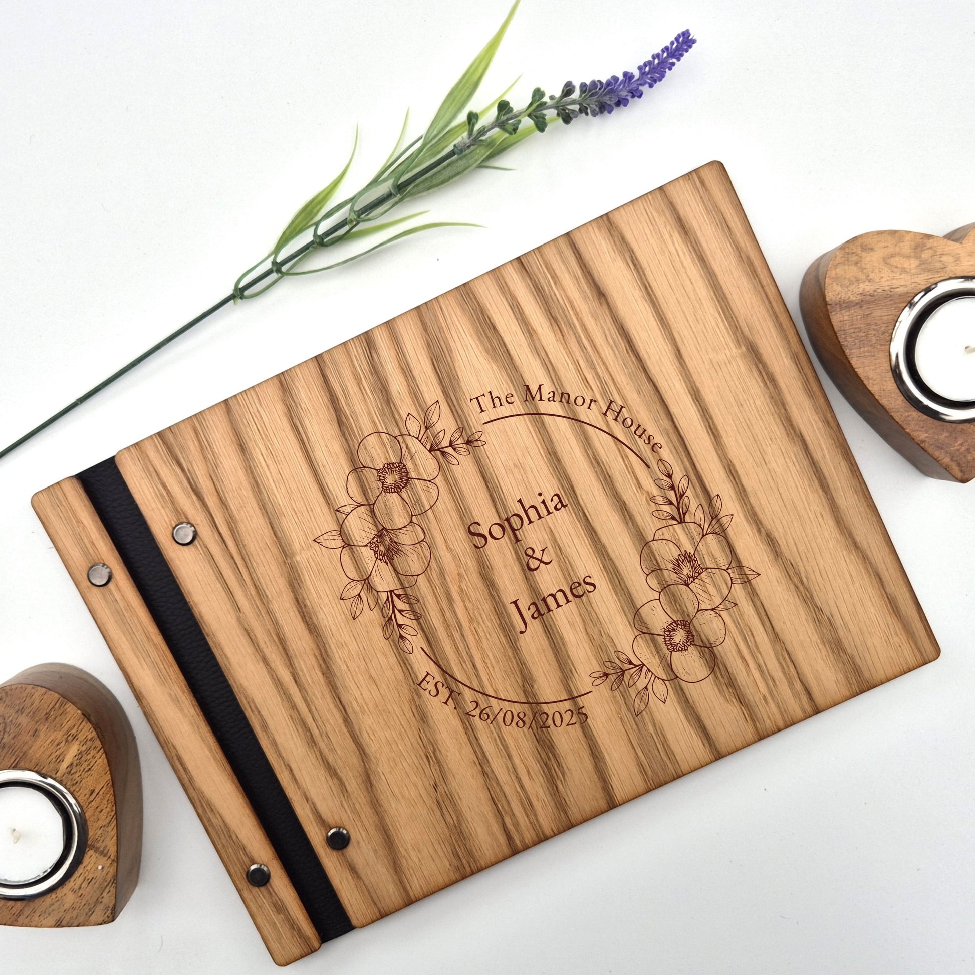 Image of a rustic style oak wedding book. The book is approximately 298mm x 216mm and includes high quality paper. The oak wedding book is laser engraved by laserengraveuk.com with a floral circular design to the front. The dsign includes the married couples names, date of wedding and the venue.