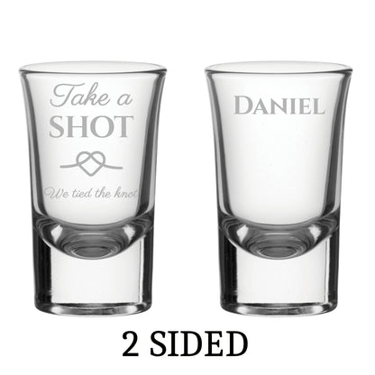 Two personalised shot glasses with engraved text on a white background