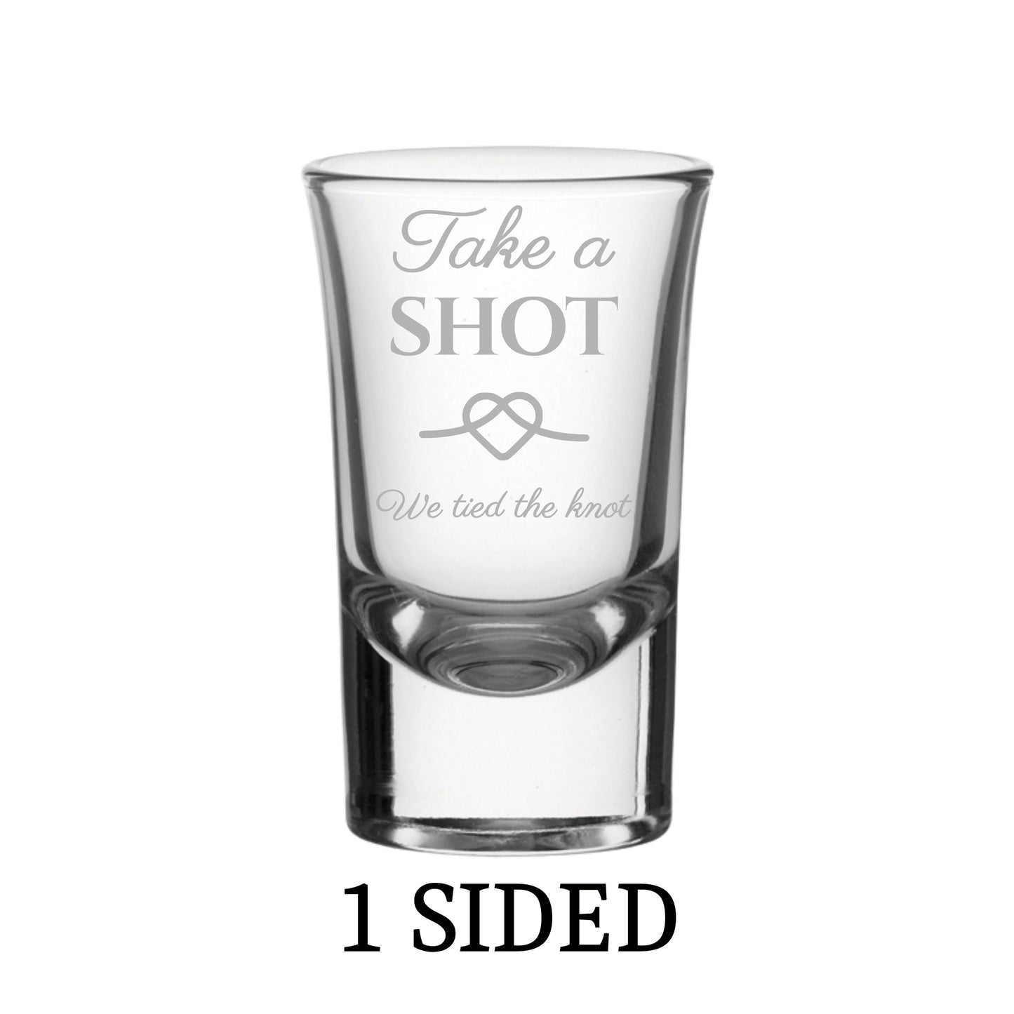 Clear shot glass with engraved text on a white background