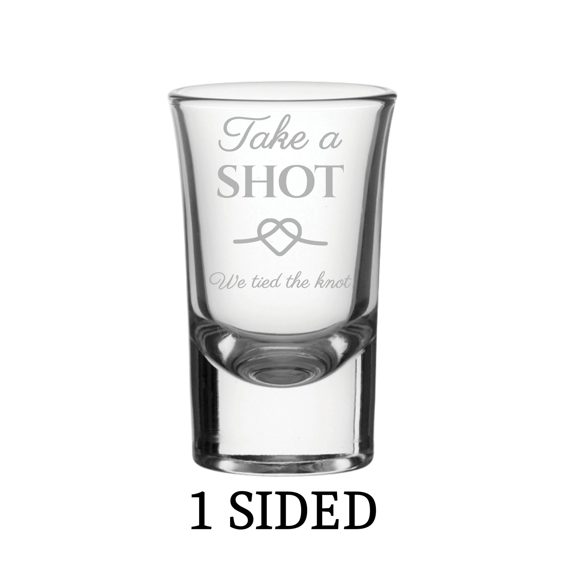 Clear shot glass with engraved text on a white background